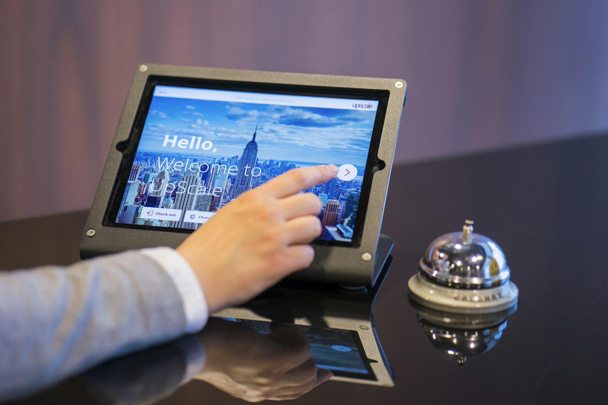 A guest checking in with a tablet at reception